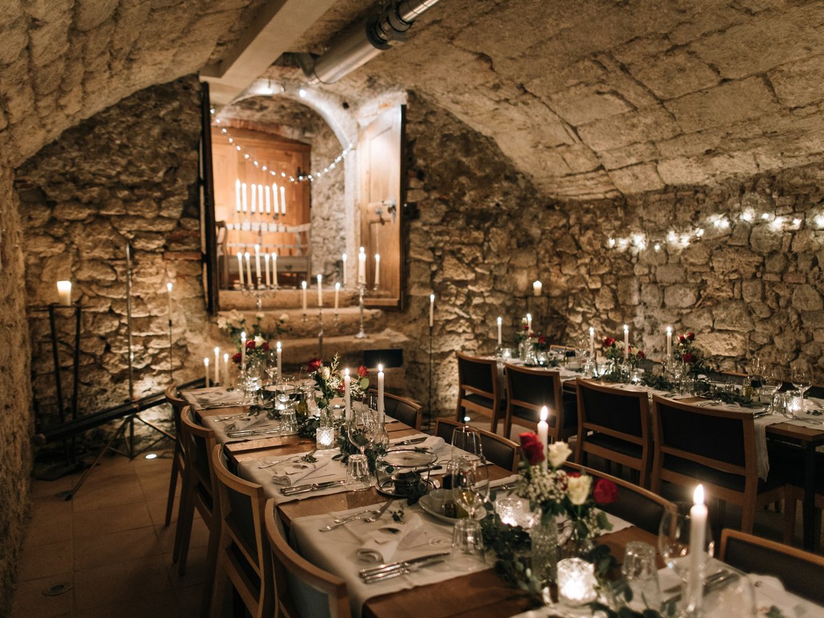 a long table set up with candles and flowers