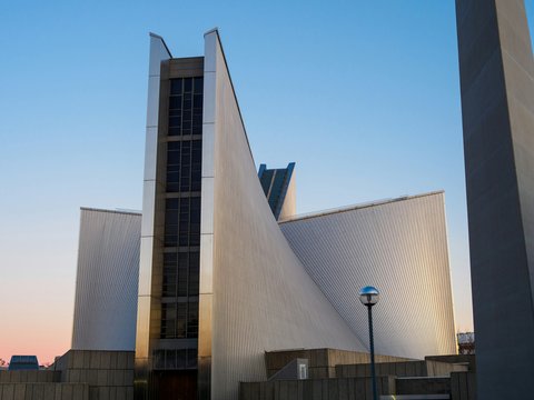 Modern church architecture against a clear blue sky