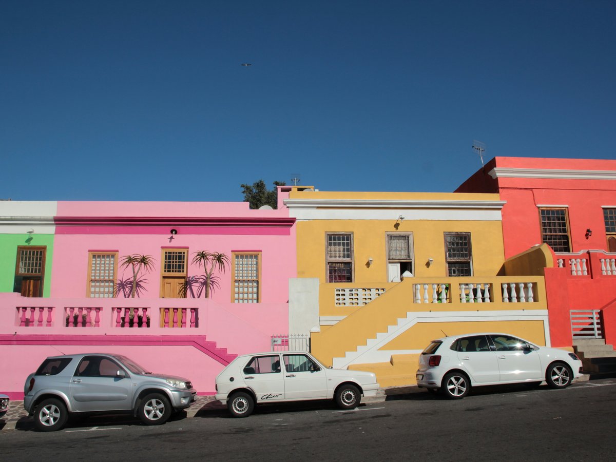 parked cars near multi-colored house