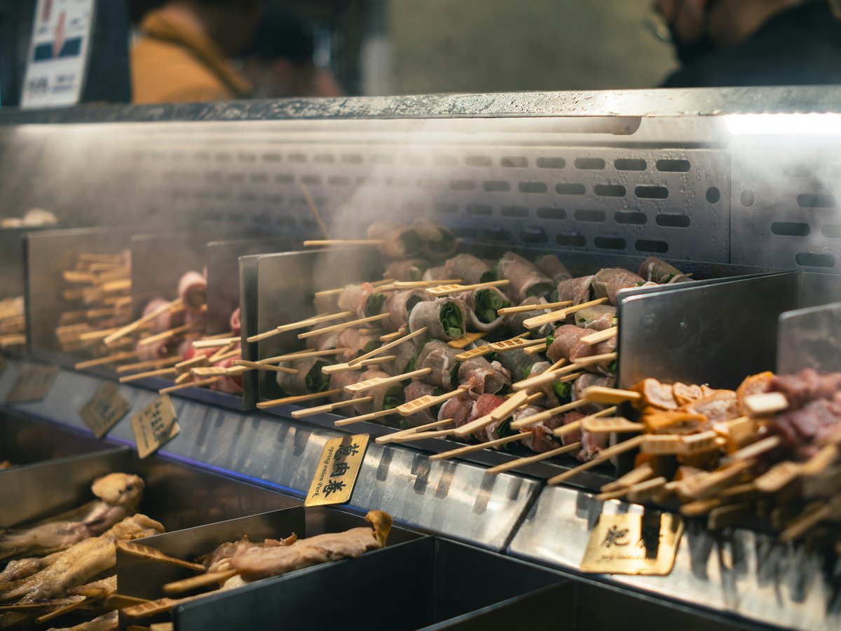 a bunch of food is being cooked on a grill