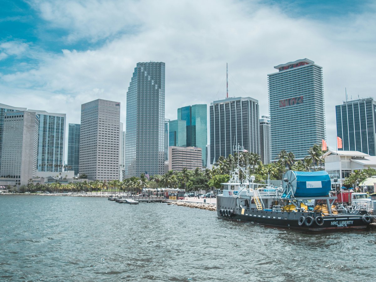 boat on water near city buildings during daytime