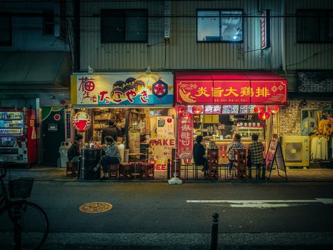 a street scene with a store front at night