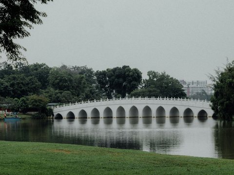 a white bridge over a body of water