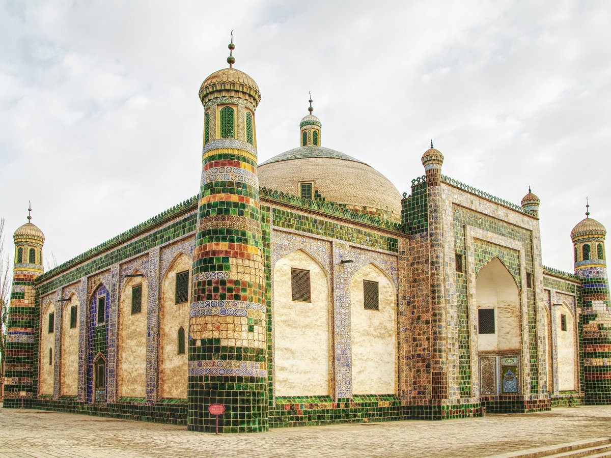 a large building with a green and white roof