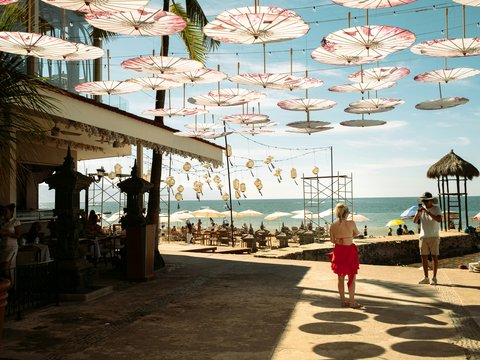 a couple of people that are standing under umbrellas