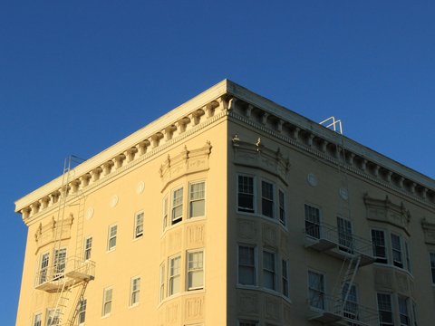 beige concrete building under blue sky