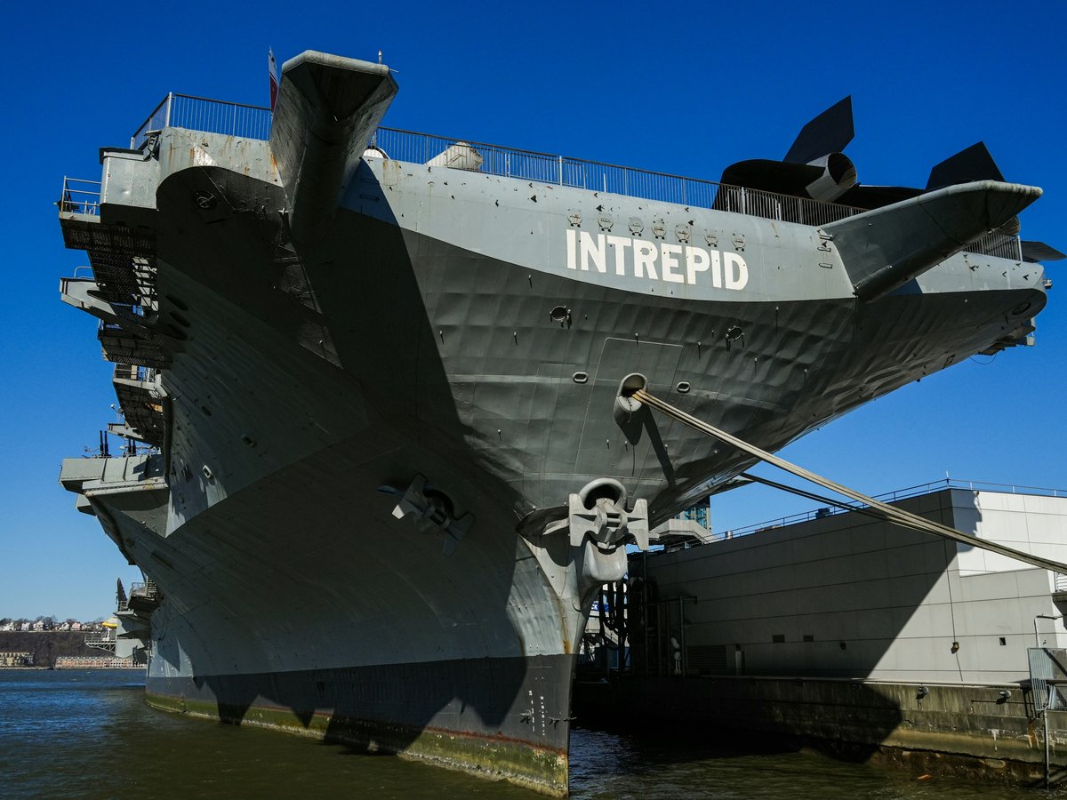 a large ship is docked at a dock