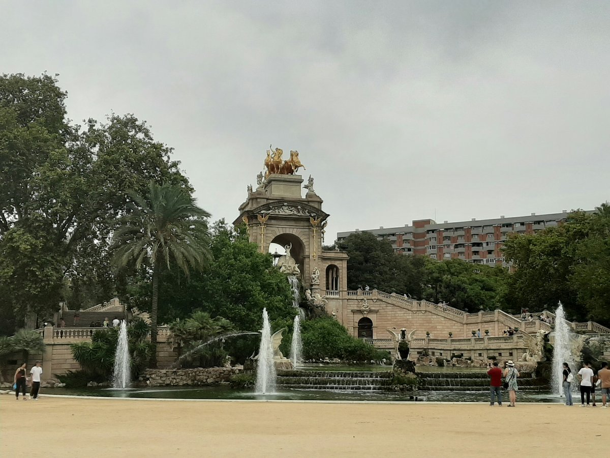 a group of people standing around a fountain