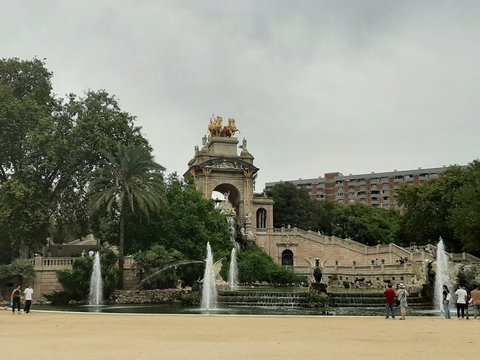 a group of people standing around a fountain
