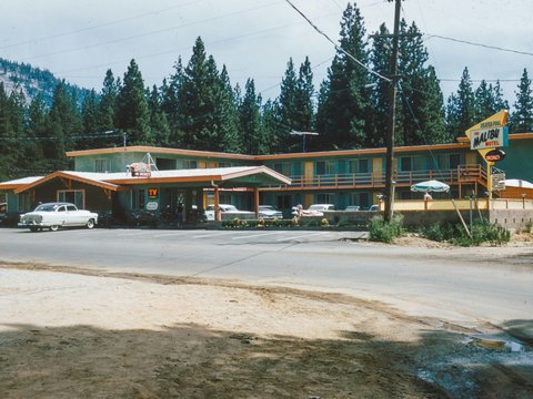 a motel with cars parked in front of it
