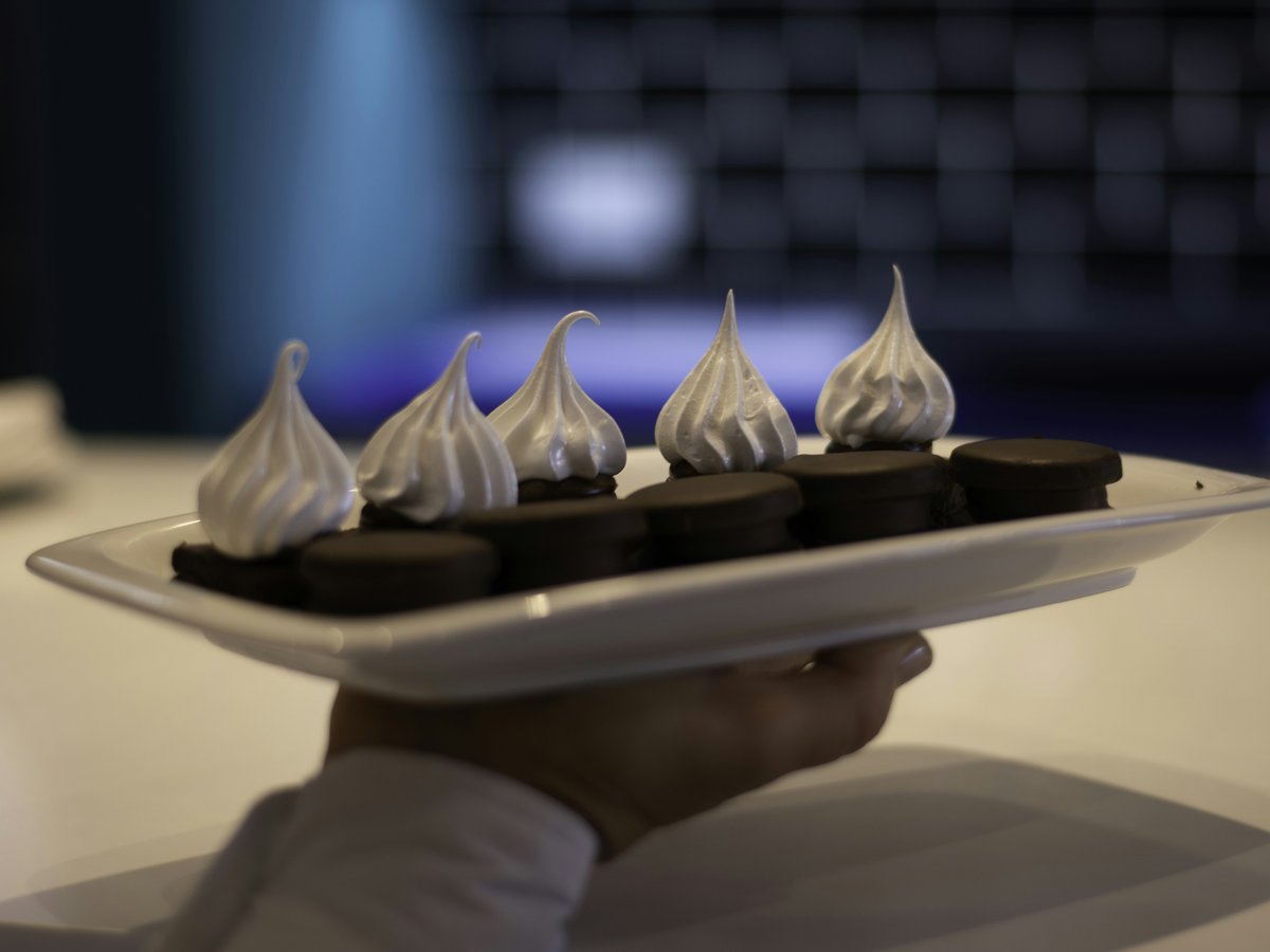 a person is holding a plate with chocolates on it