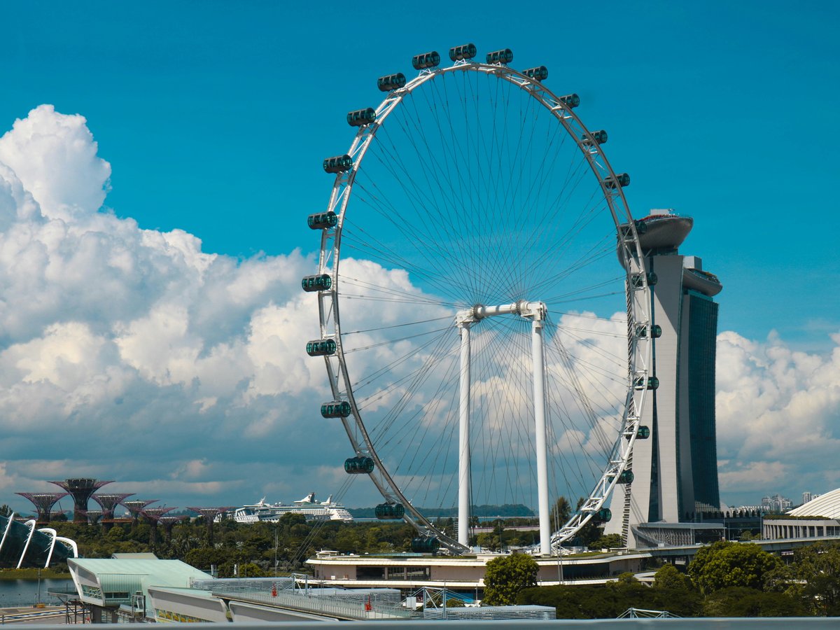 Ferris Wheel beside high-rise building during daytime