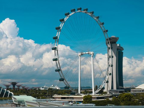 Ferris Wheel beside high-rise building during daytime