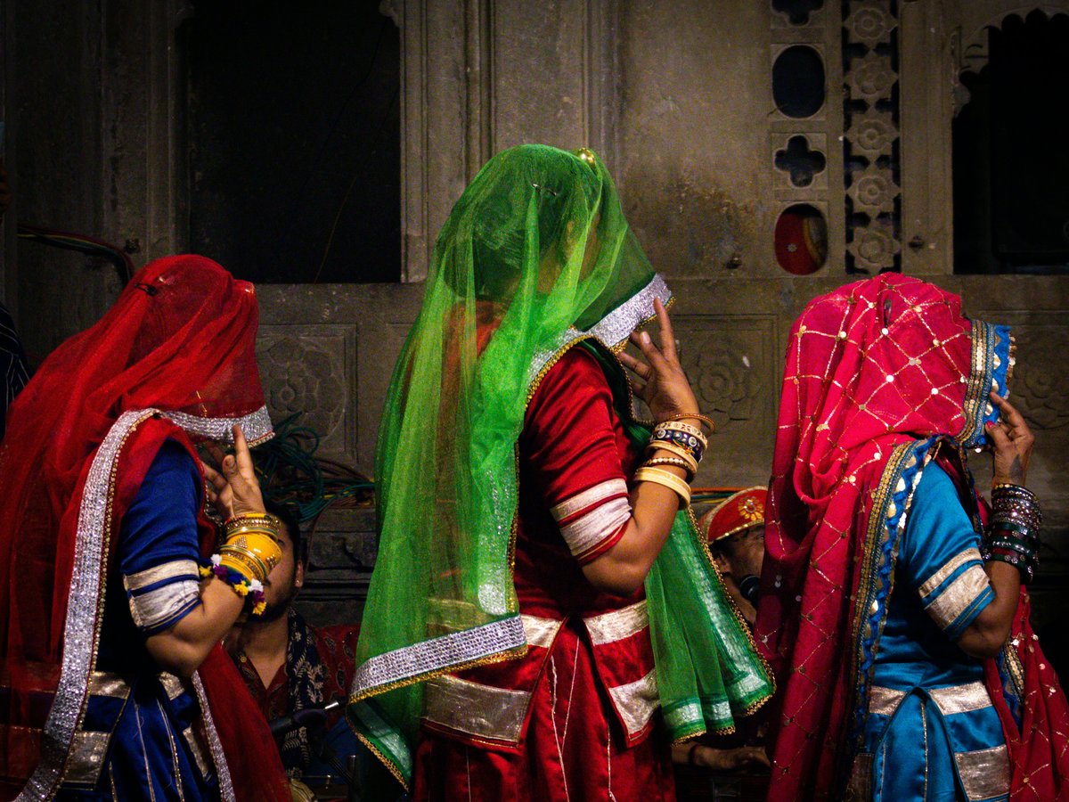 Three women in colorful traditional indian attire