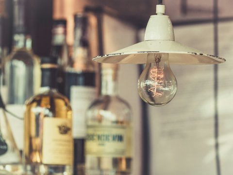 Edison bulb near bottles