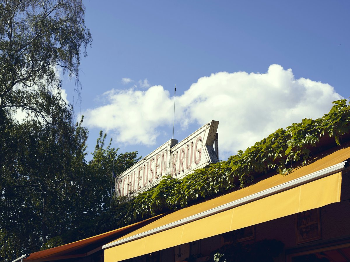 A yellow building with a sign on top of it
