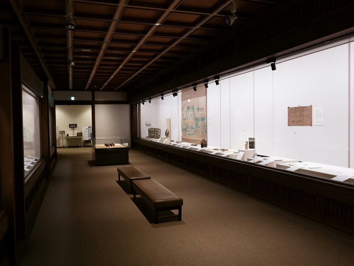 An art gallery hallway with displays and benches.