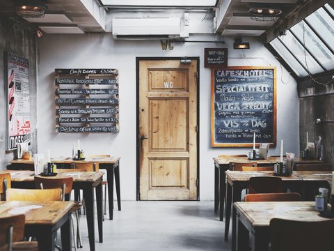 brown wooden door between table and chairs
