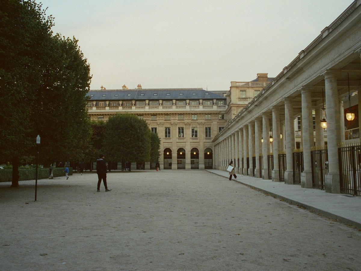 a couple of people standing in front of a building
