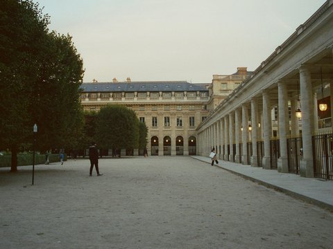 a couple of people standing in front of a building