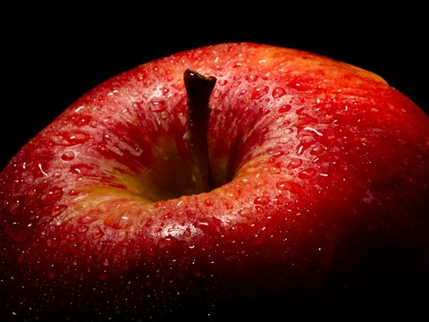 A red apple with water droplets on it