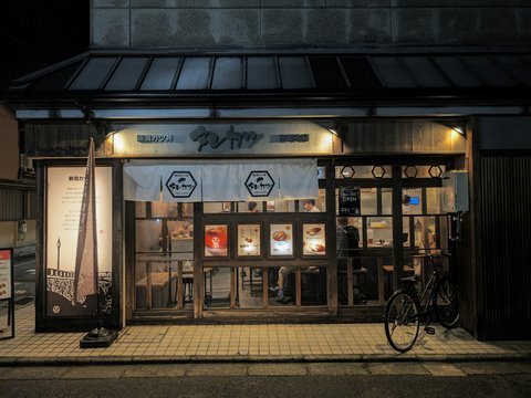 A bike is parked outside of a building