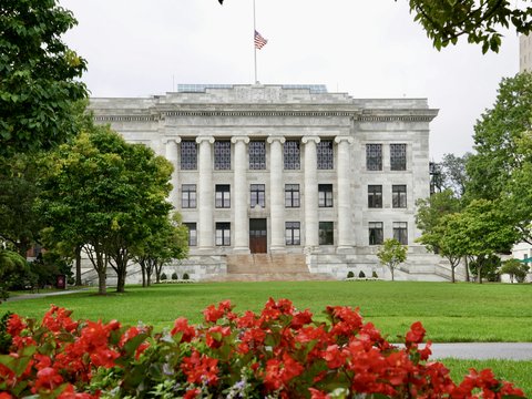 a large white building with a flag on top