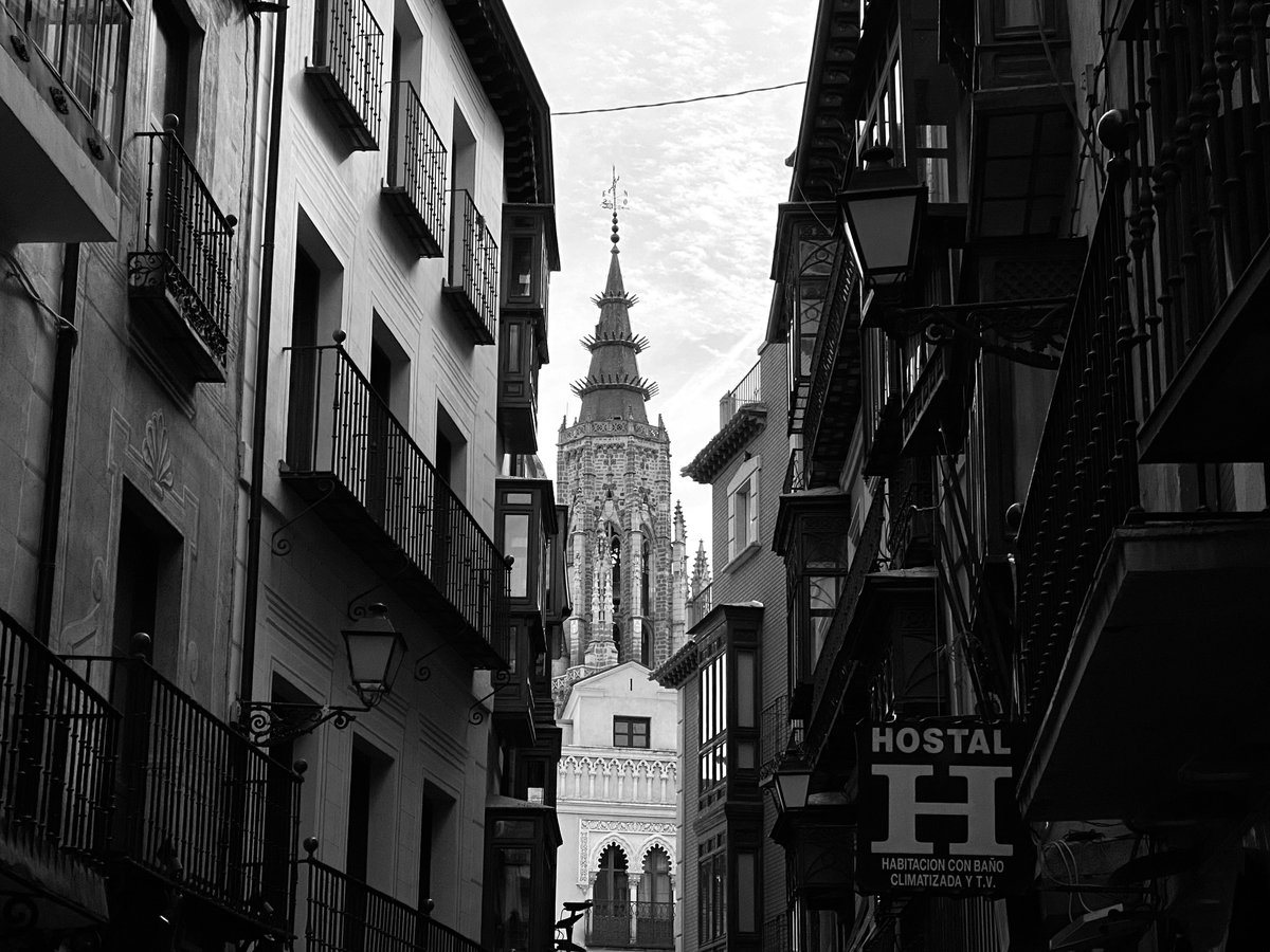 Narrow street view towards a cathedral tower