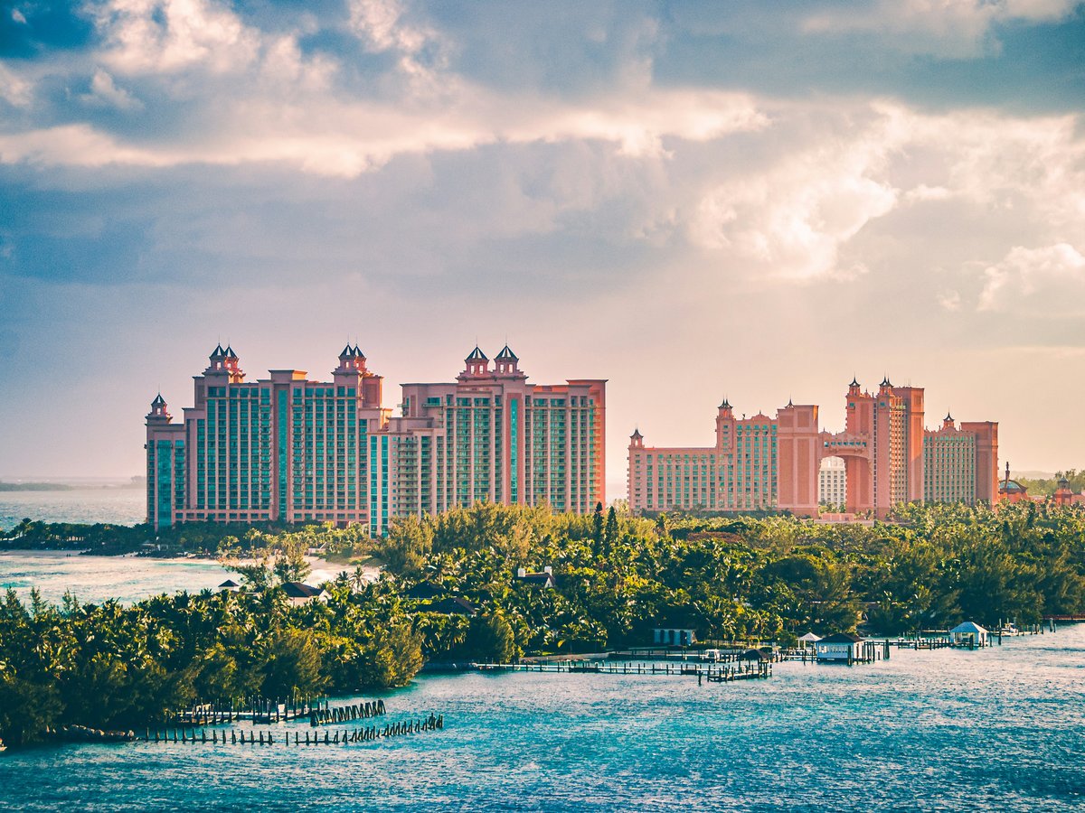 a view of a resort and a body of water
