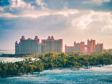 a view of a resort and a body of water
