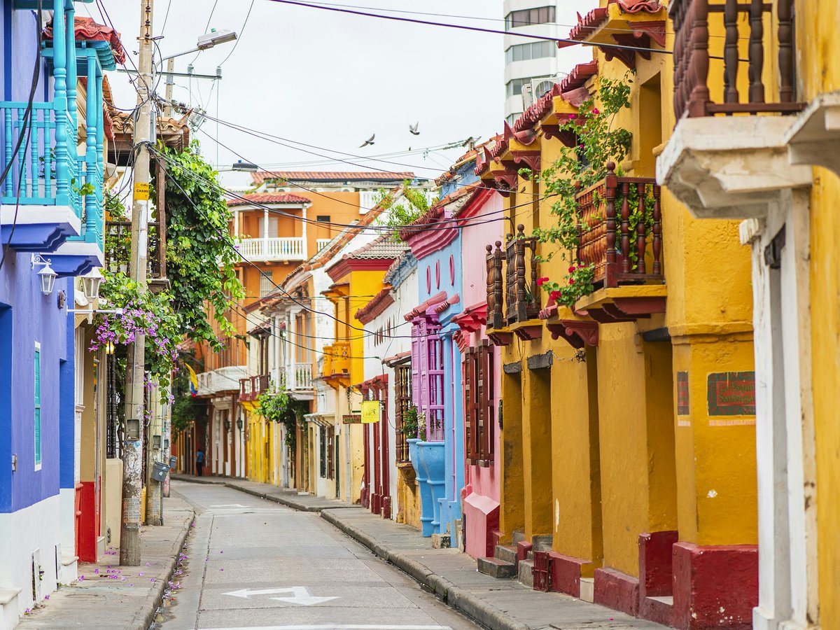 a narrow city street lined with colorful buildings