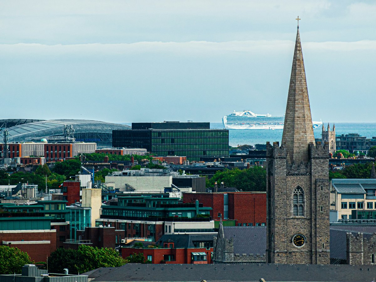 a view of a city with a boat in the background