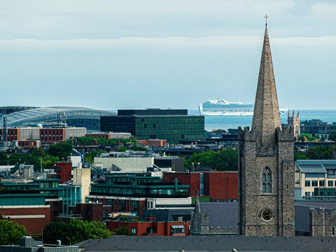 a view of a city with a boat in the background