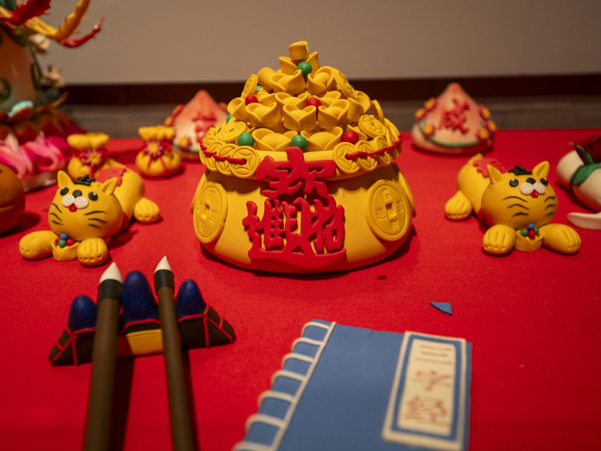 A red table topped with lots of toys