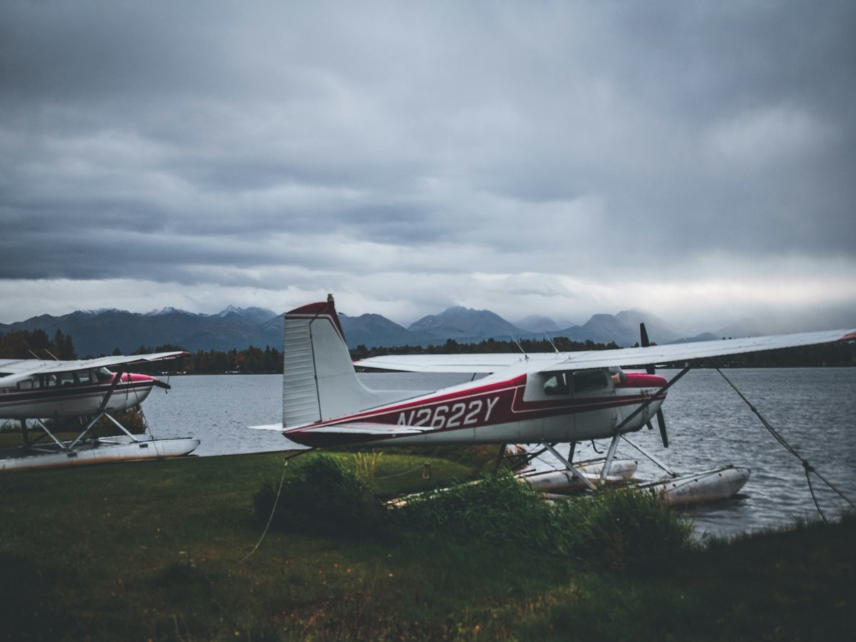 a small plane sitting on top of a lush green field