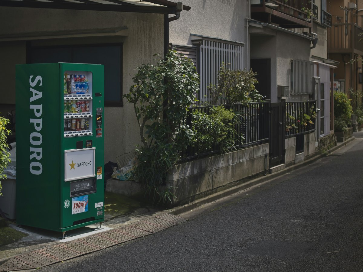 a vending machine sitting on the side of a street