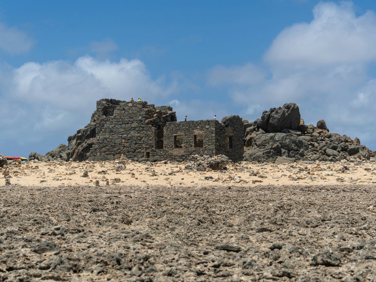 an old building in the middle of a desert