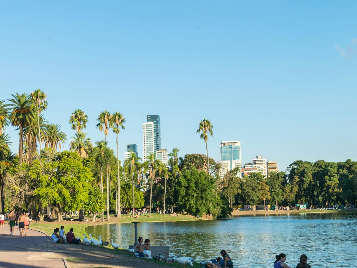 people sitting on concrete bench near body of water during daytime