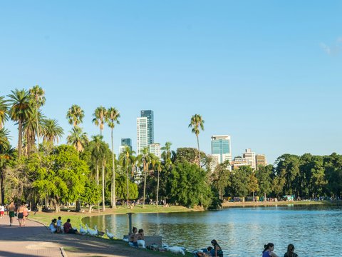 people sitting on concrete bench near body of water during daytime