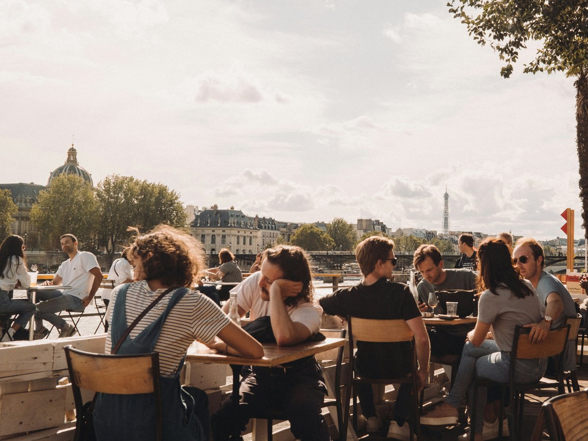 people sitting on brown wooden chairs during daytime