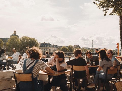 people sitting on brown wooden chairs during daytime