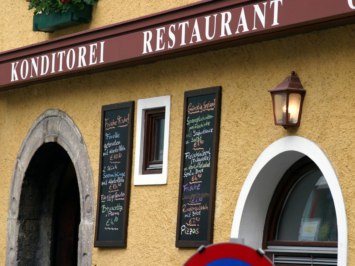 a restaurant with menus on the outside of it