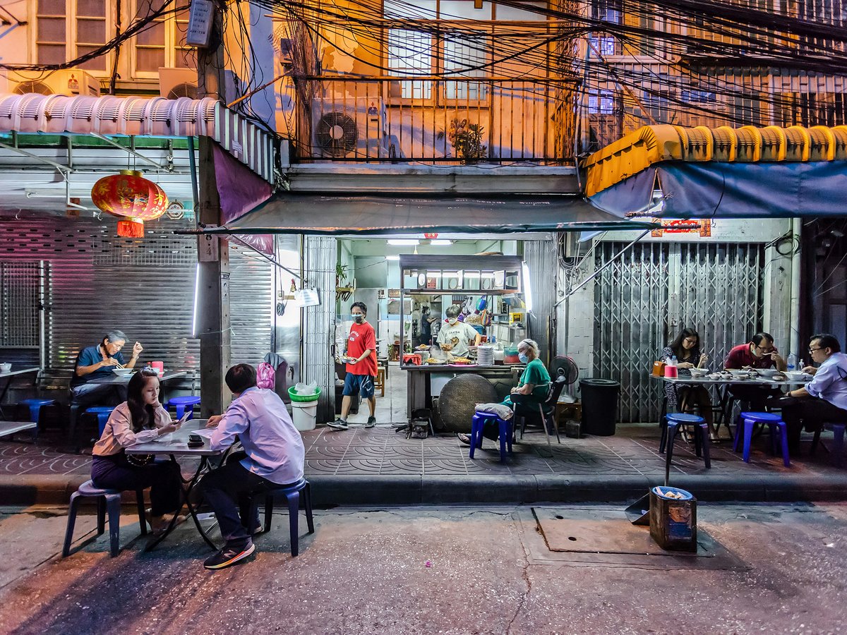 people sitting on chair near food stall during daytime
