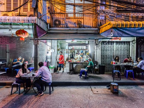 people sitting on chair near food stall during daytime