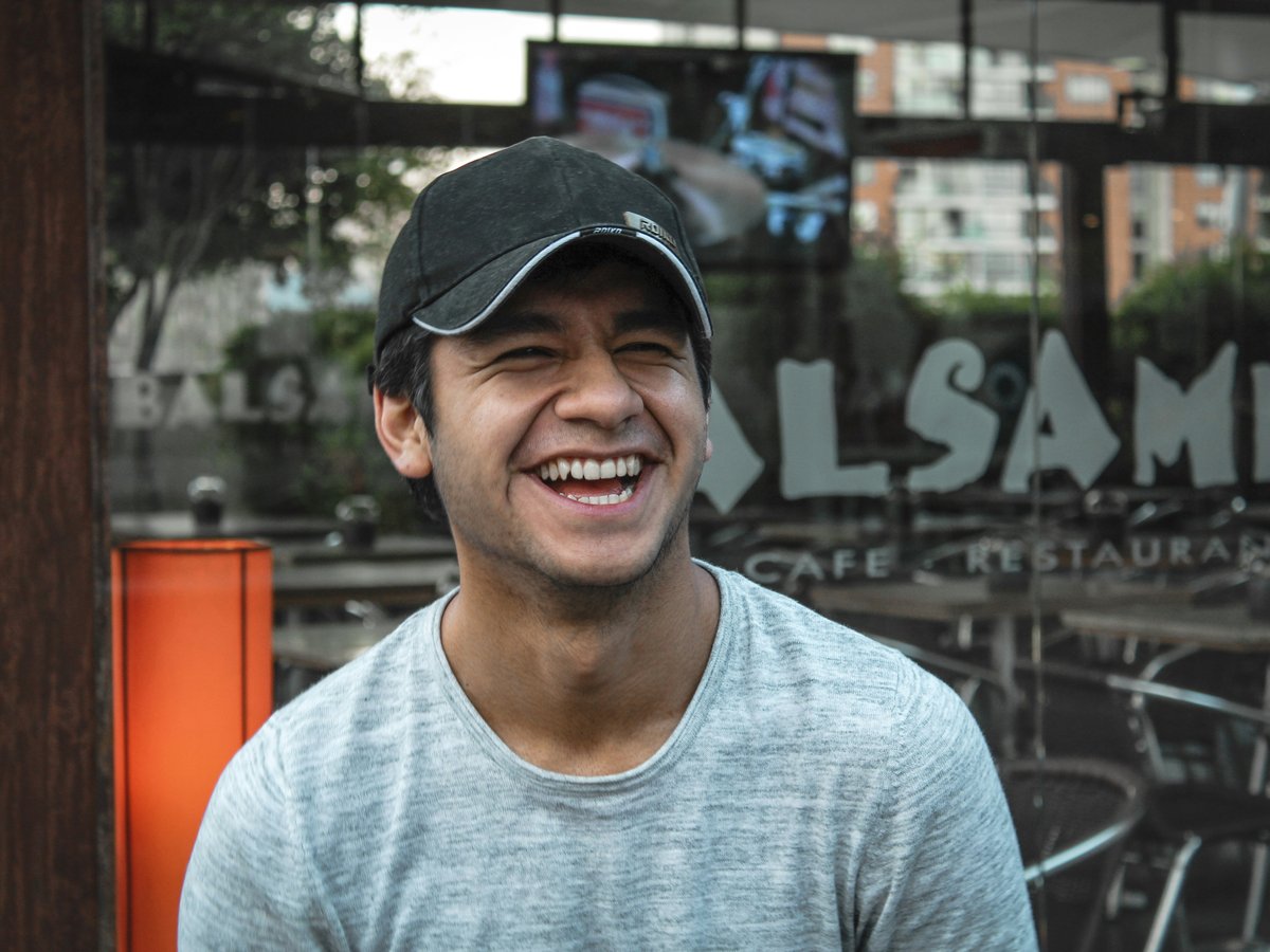 man in gray crew neck shirt wearing black cap
