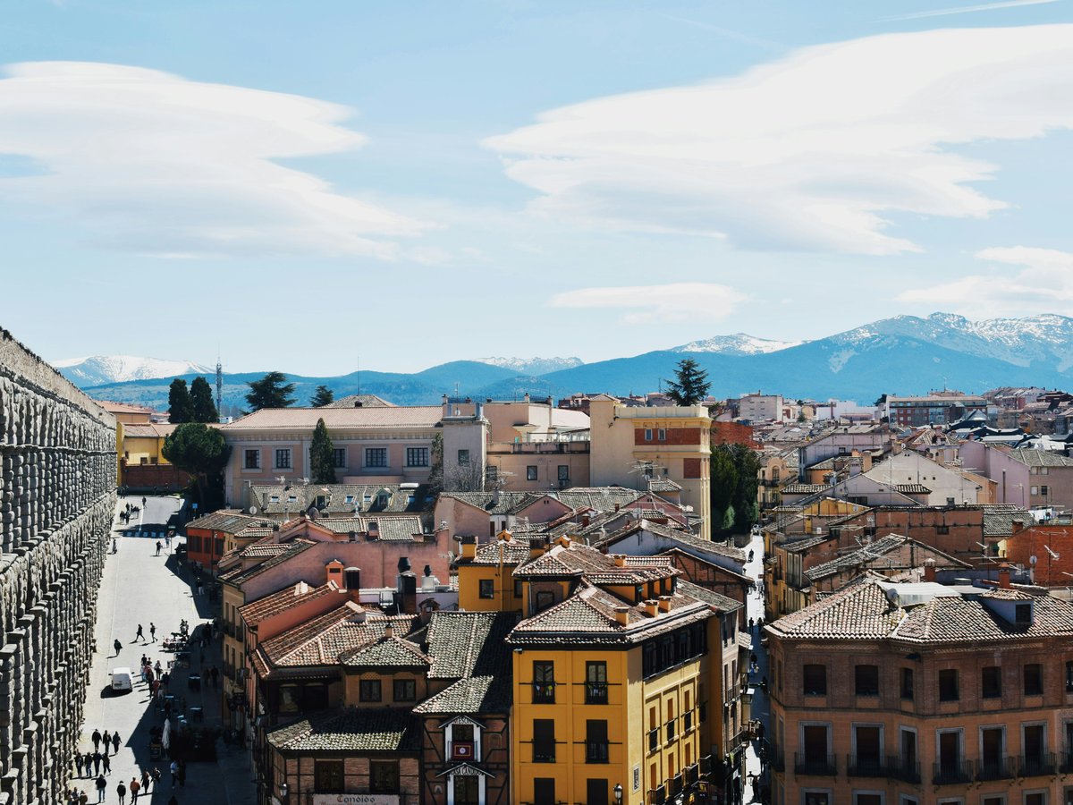Cityscape with snow-capped mountains in the distance