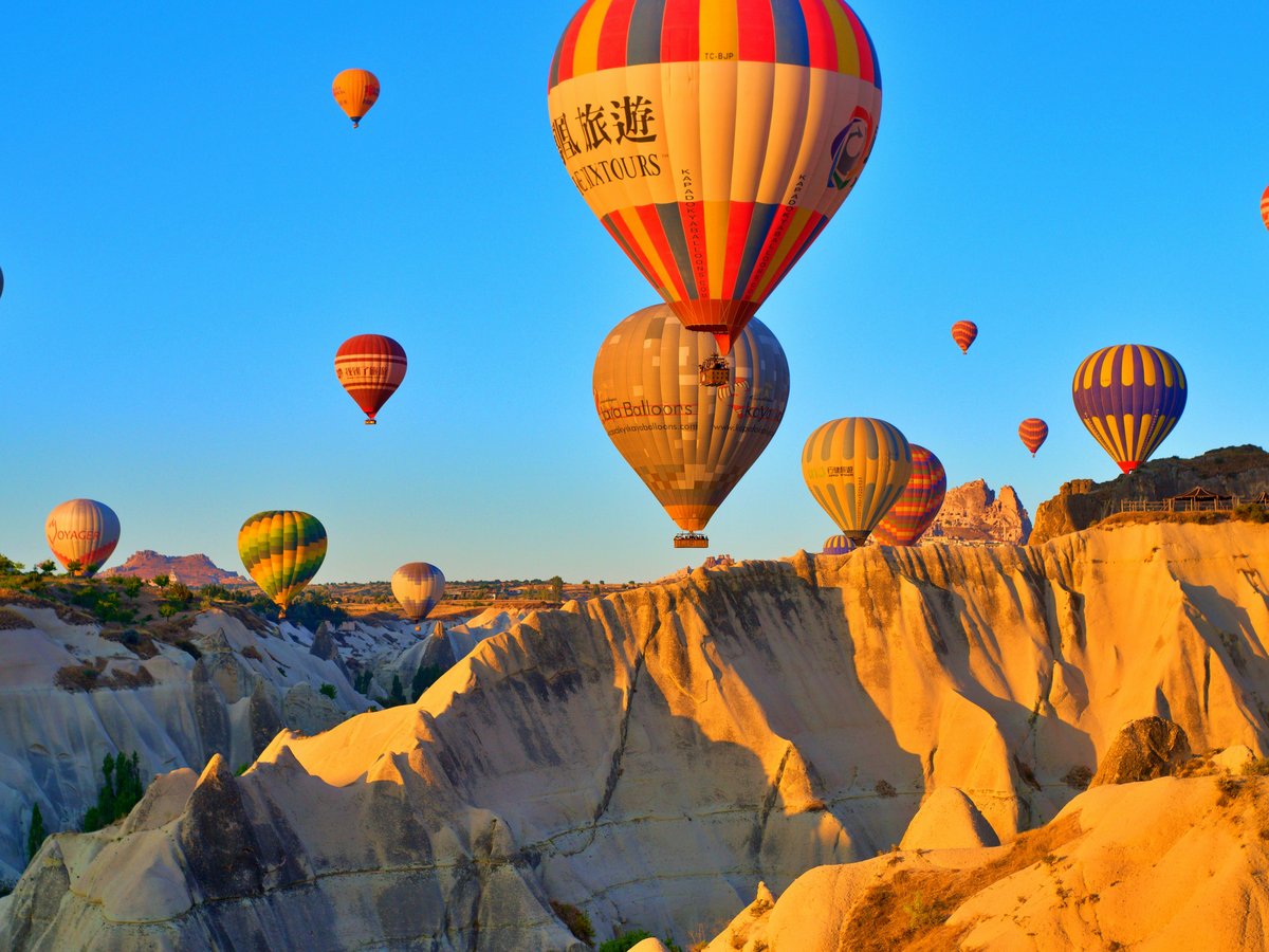 a group of hot air balloons flying in the sky