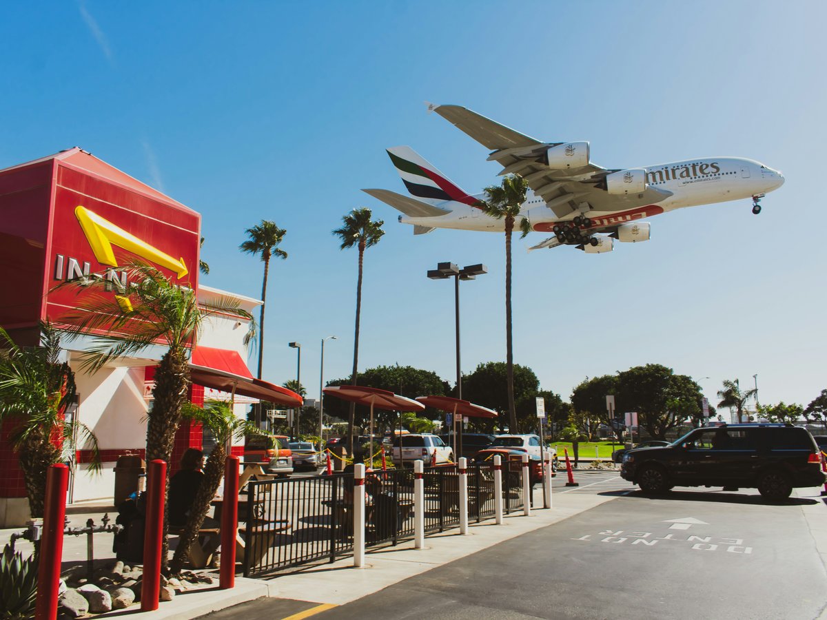 an airplane is flying over a mcdonald's restaurant