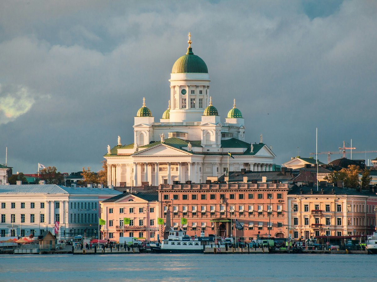 white concrete mosque near body of water
