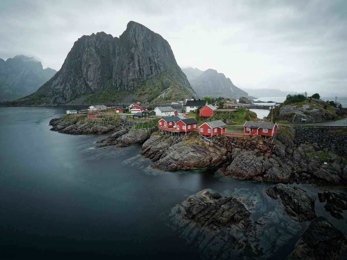 red and black houses beside sea